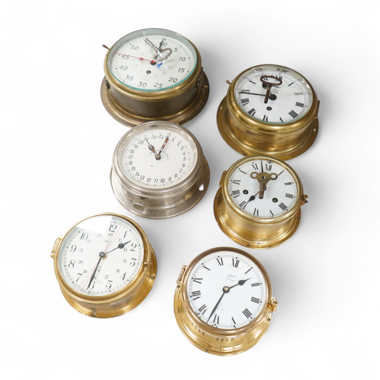 A ship's clock by Story of Barrow, a CCCP ship's clock and four other brass examples, some with keys, largest 28cm in diameter